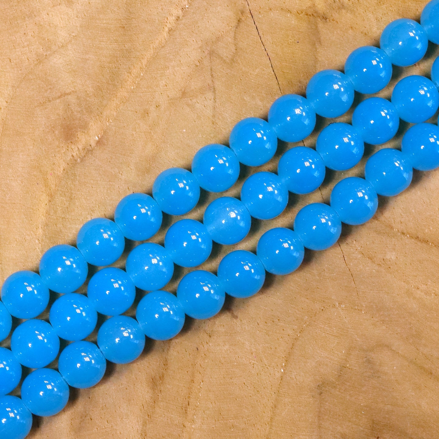 Gekleurde glaskralen per streng - blauw