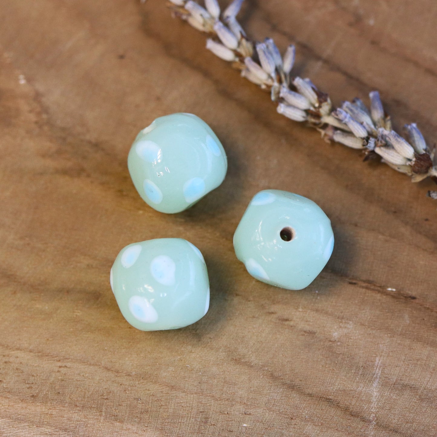 Bead green - glass bead rounded with blue dots