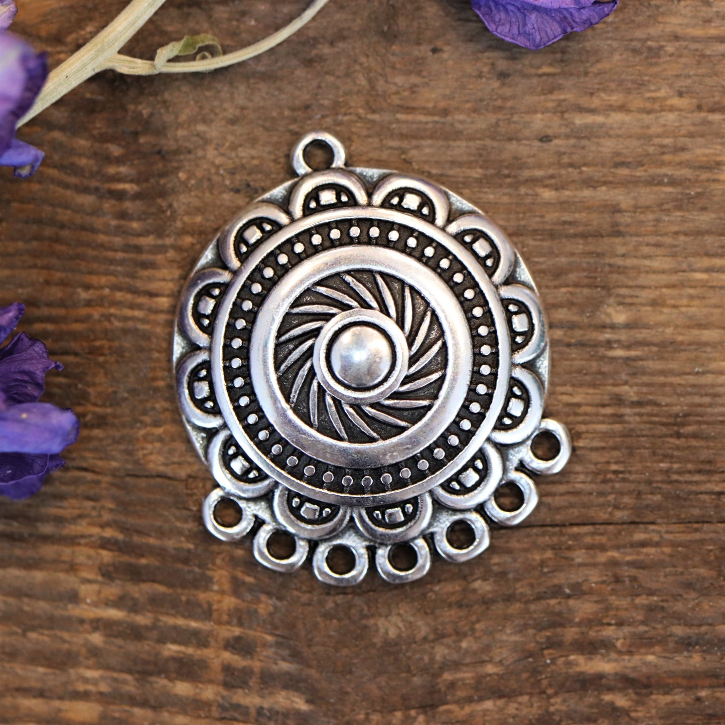 DQ silver charm with 7 eyes at the bottom