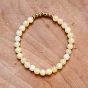 Armband kralen lichtgeel met goud