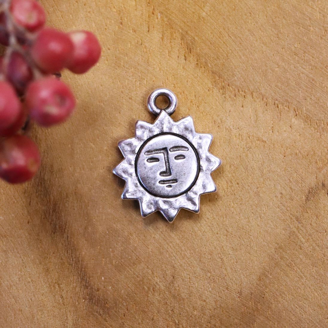DQ silver sun charm