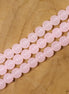 Gekleurde glaskralen per streng - zacht roze