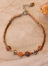 Armband van bruin koord met kralenbloemen