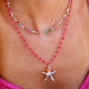 Kralenketting- roze met zilveren zeesterbedel