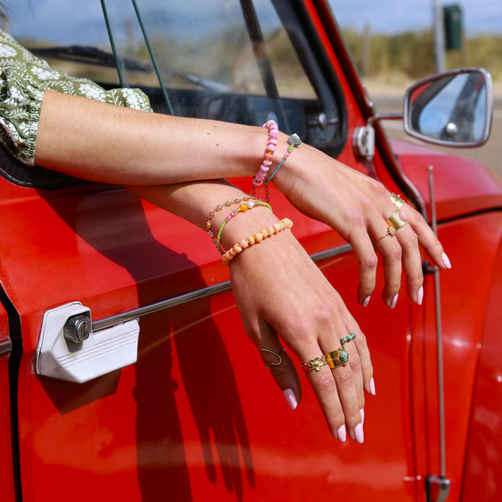 Armband grün mit oranger Blume