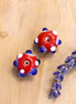 Bead red - ceramic round with dark blue dots