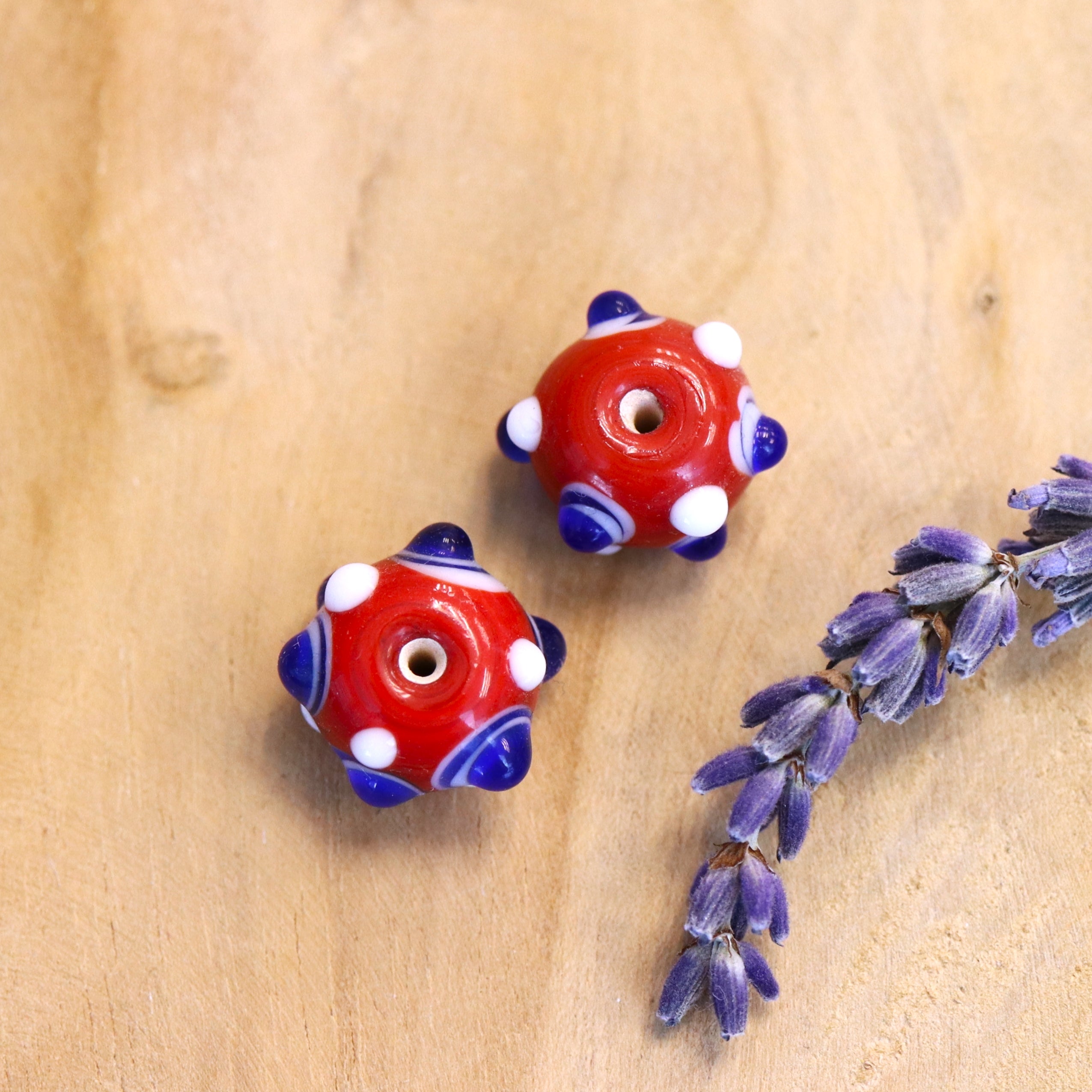 Bead red - ceramic round with dark blue dots