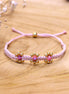 Knotted bracelet with flowers - light pink