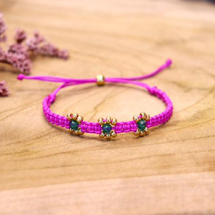 Knotted bracelet with flowers - fuchsia