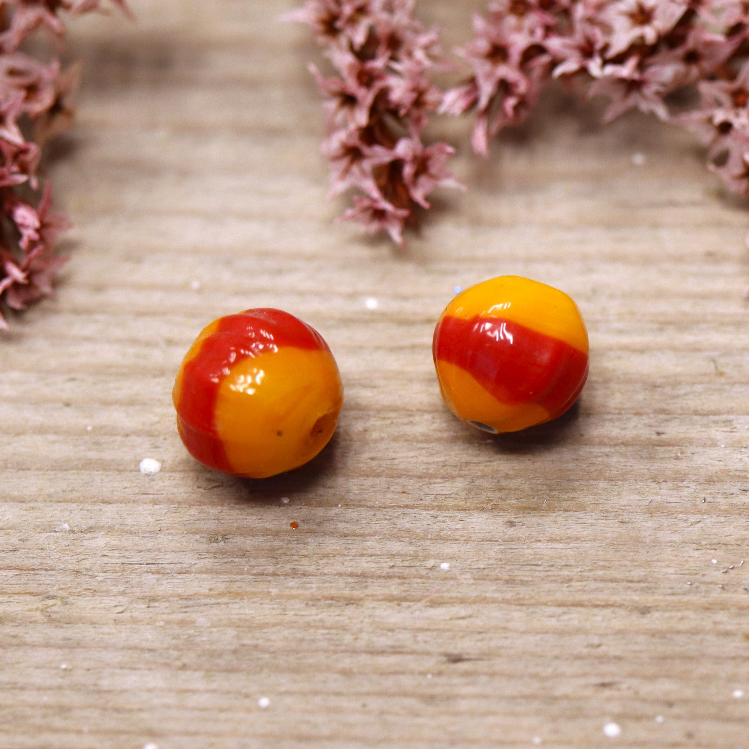 Bead orange - ceramic round with ribbed pattern and red stripe