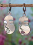 Stainless steel oorbellen met gezicht zilver