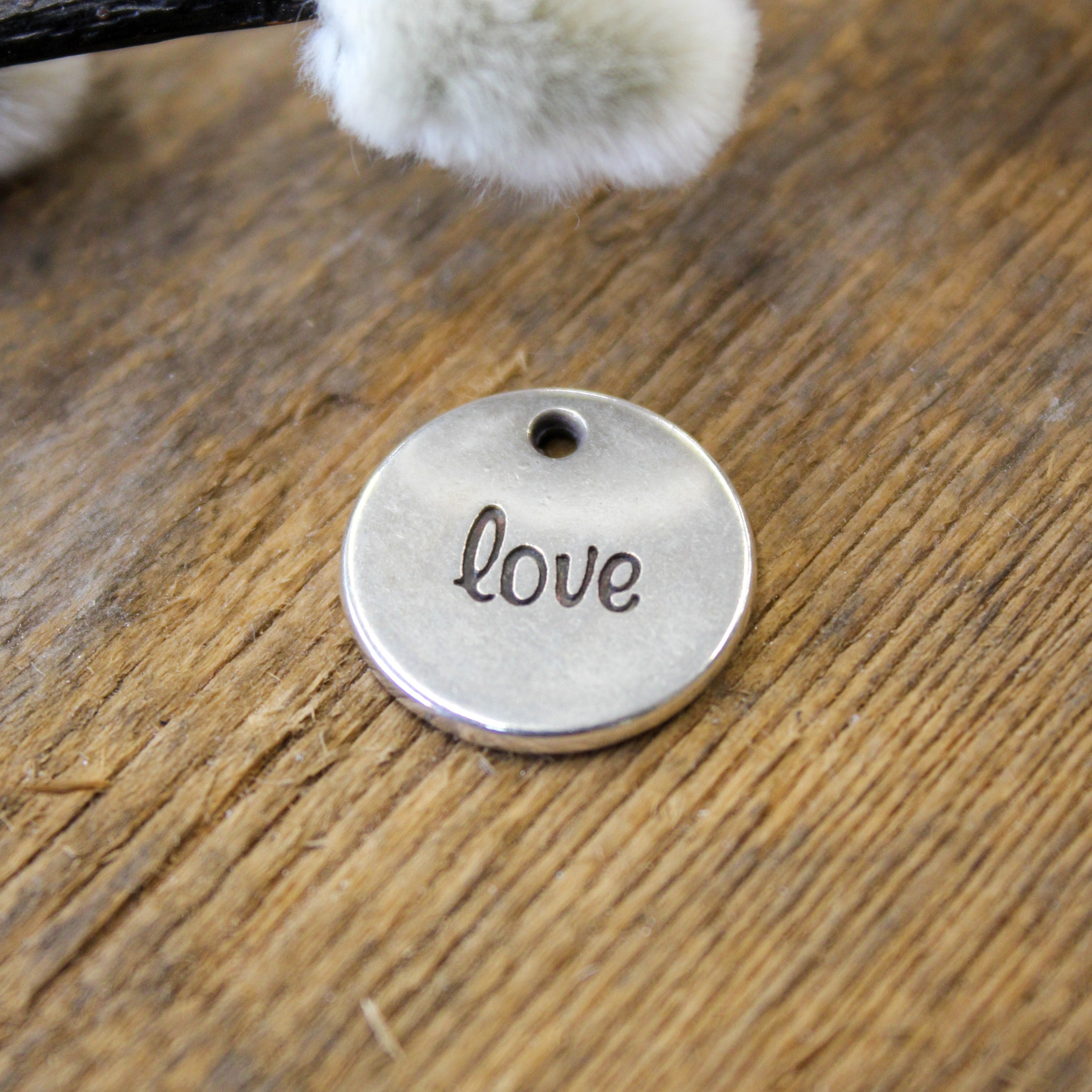 DQ silver charm with text on both sides 'love/amour'