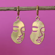 Stainless steel oorbellen met gezicht goud